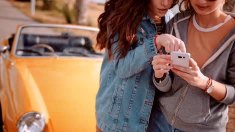 Mujeres-con-smartphone-y-leer-en-línea-mapa-de-viaje-por-carretera