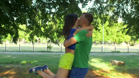 Joyful-sporty-couple-meeting-during-outdoors-workout