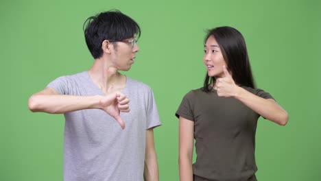 Young-Asian-couple-having-different-decisions-together