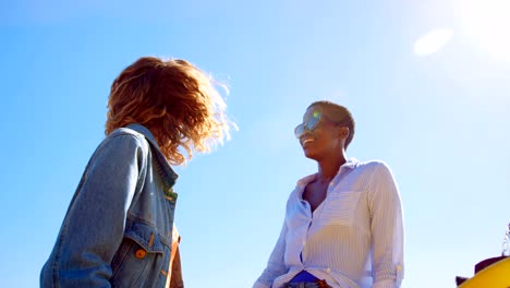 Female-friends-having-beer-in-the-beach-4k