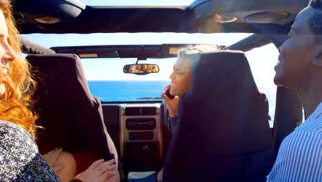 Group-of-female-friends-interacting-each-other-in-the-car-4k