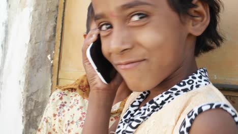 Indian-kids-talking-on-mobile-cell-phone,-excited-and-happy,-talking