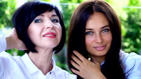 Portrait-of-two-pleasant-smiling,-beautiful-real-40-years-old-women.-Happy-middle-aged-friends-meeting