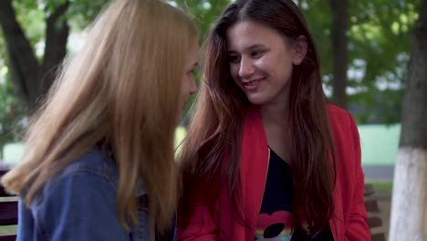 Two-girls-are-chatting-at-the-park