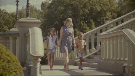 Diverse-family-walking-downstairs-in-travel-location