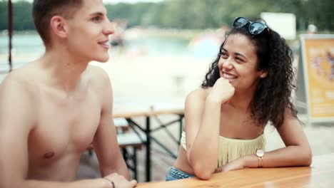 Couple-man-and-woman-dating-by-a-lake,-outdoors.