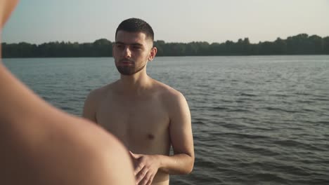 Two-young-men-communicate-on-the-river-bank