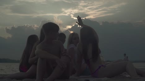 Teenagers-rest-on-the-river-bank