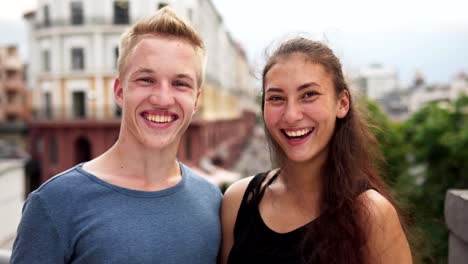 Happy-mixed-race-guy-and-girl-smiling-at-urban-street-on-summer