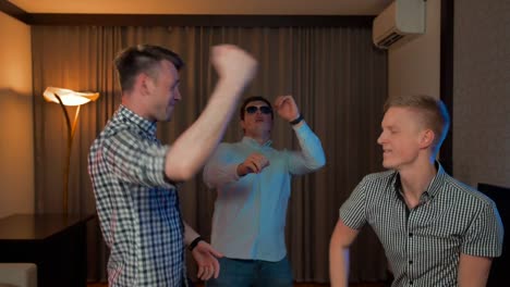 Group-of-guys-dancing-in-the-flat-home-living-room