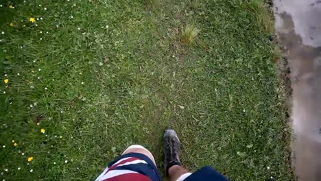 Men's-legs-in-the-brown-shoes-lying-on-the-mountain-on-the-sea-scape-background