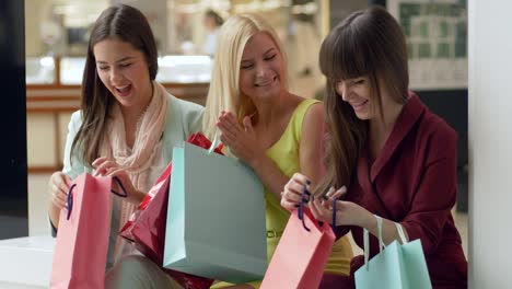 shopaholism,-emotional-company-female-brag-about-new-shopping-from-fashion-stores-in-season-of-sales-and-discounts-on-black-Friday-with-lot-bags