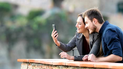 Happy-couple-having-a-video-call-with-a-smart-phone