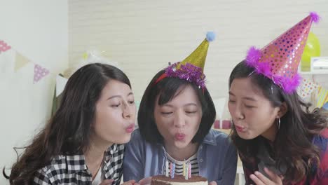 birthday-girls-blowing-out-candles-on-cake