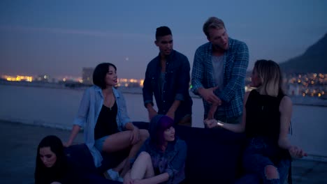 Hipster-girls-partying-around-a-couch-on-a-rooftop