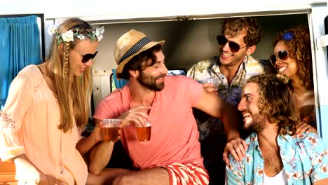 Group-of-friends-drinking-some-beer-and-sitting-on-the-van