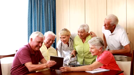 Female-doctor-interacting-with-senior-citizens