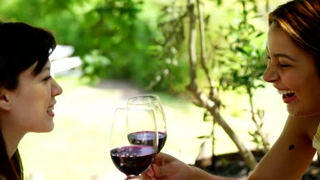 Two-friends-toasting-red-wine-glasses