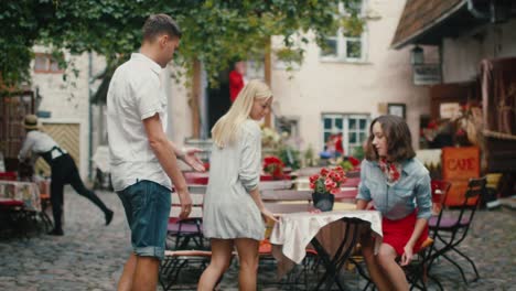 Happy-Young-People-are-Coming-to-Outdoor-Coffee-Shop