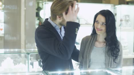 Young-Couple-in-Jewellery-Store-is-Watching-at-Display-Windows