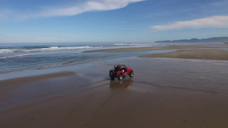 Aerial-shot-of-off-road-vehicle-driving-on-beach