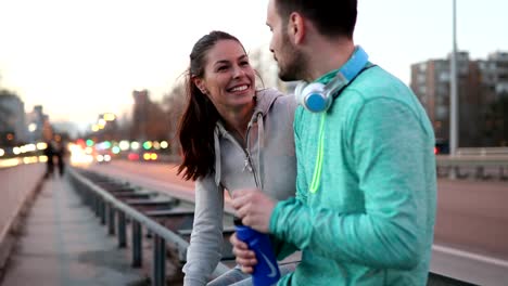 Beautiful-couple-talking-after-fitness-exercising-and-jogging