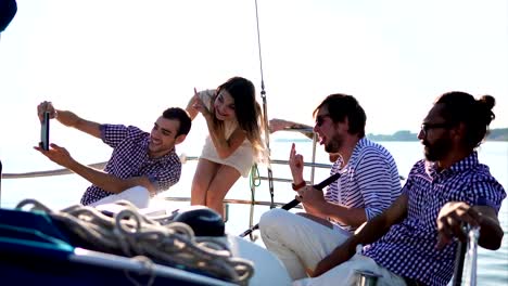 Friends-having-a-rest-on-the-yacht-and-making-touch-pad-selfie