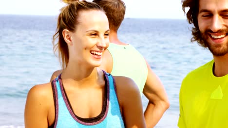 Fit-man-and-woman-interacting-with-each-other-on-the-beach