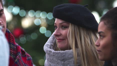 Friends-Stand-In-Front-Of-Christmas-Tree-On-South-Bank-In-London