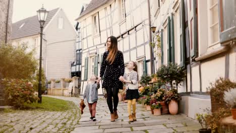 Beautiful-woman-walking-with-two-children.-Holding-hands.-European-mother,-girl-and-boy-together.-Hattingen,-Germany-4K