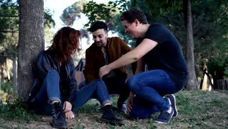 Portrait-of-two-affectionate-friends-consoling-their-friend-to-the-park