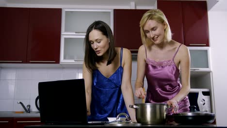 Female-friends-reading-online-recipe-and-cooking
