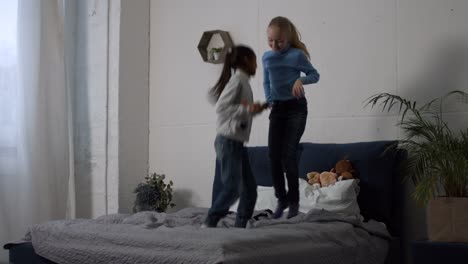 Positive-multi-ethnic-kids-jumping-on-the-bed