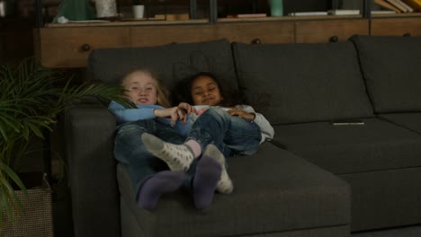 Two-multiracial-little-girls-playing-on-the-couch