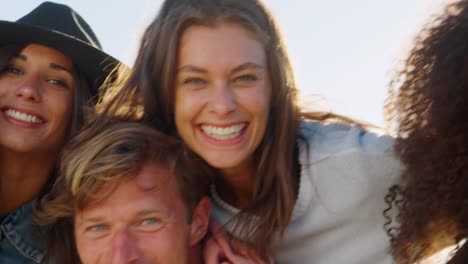 Portrait-Of-Men-Giving-Women-Piggybacks-On-Winter-Beach-Vacation