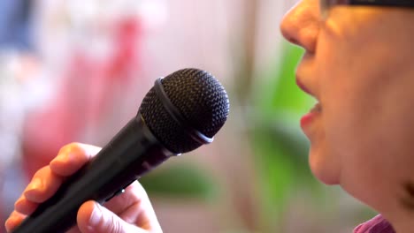 Senior-woman-signing-with-microphone-karaoke-in-slow-motion-4k-slow-motion