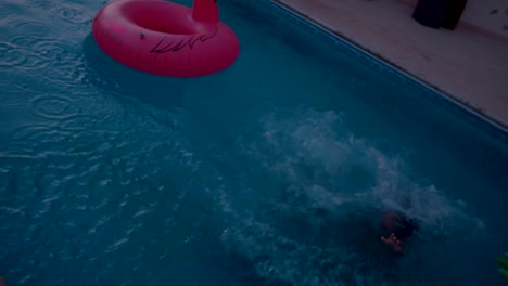 Women-on-summer-holidays-having-fun-jumping-into-swimming-pool