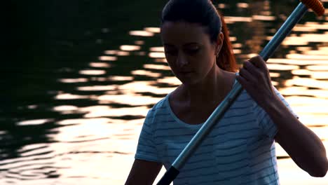 Close-up,-Beautiful-Girl-Picks-Oars-Standing-on-Sup