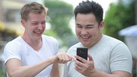 Two-young-multi-ethnic-handsome-men-together-in-the-streets-outdoors