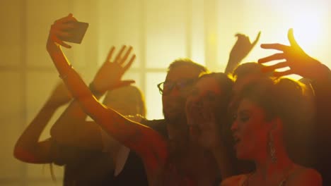 Joyous-Friends-Taking-Selfie-in-Nightclub