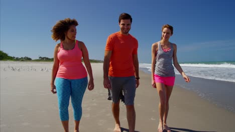 Multi-ethnic-friends-enjoying-fitness-activity-on-beach