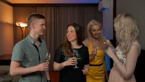 Group-of-happy-friends-with-cocktails-toasting-at-party