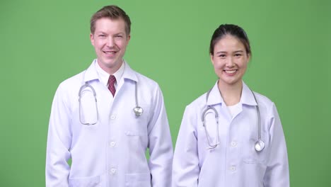 Médicos-de-la-feliz-pareja-multiétnica-sonriendo-juntos