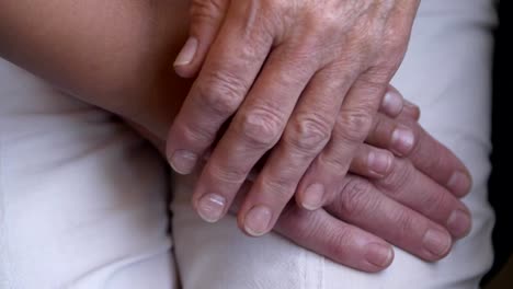 the-hand-of-a-child-falls-on-the-hand-of-an-elderly-woman