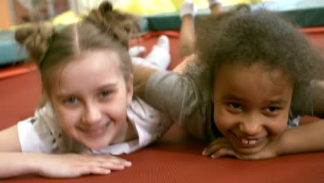 Multi-Ethnic-Girls-Lying-on-Trampoline