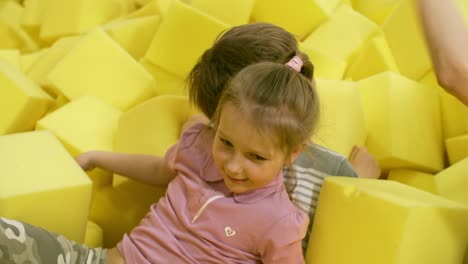 Playful-Children-Fighting-with-Foam-Cubes