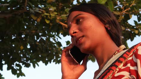 Two-girlfriends-talk-on-the-mobile-phone-happy-call-exchange-phone-park-deserted-hill-top-lover-joy-share-love-bond-together-summer-hot-day-teamwork-handheld-stabilized-two-shot-medium-close-up-look