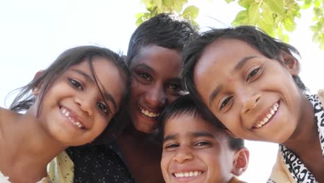 Indian-children-portrait-happy-and-excited,-playing-and-making-merry-in-sand-area-in-Rajasthan-state-of-India