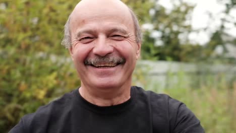 Mature-caucasian-man-whirling-and-smiling.