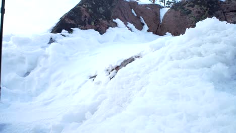 Young-people-on-winter-hike-in-mountains,-backpackers-walking-on-snow